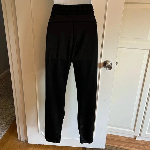Lululemon black joggers with drawstring elastic waist band, and hemline.  Size 4 - Picture 4 of 13